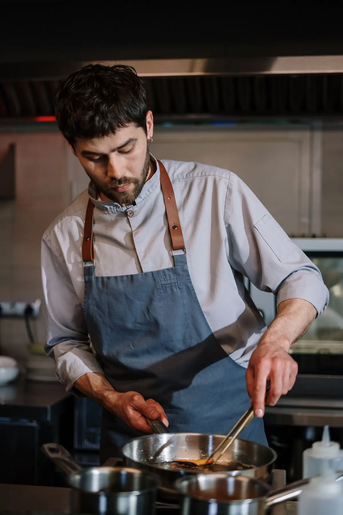A cook preparing food in a kitchen